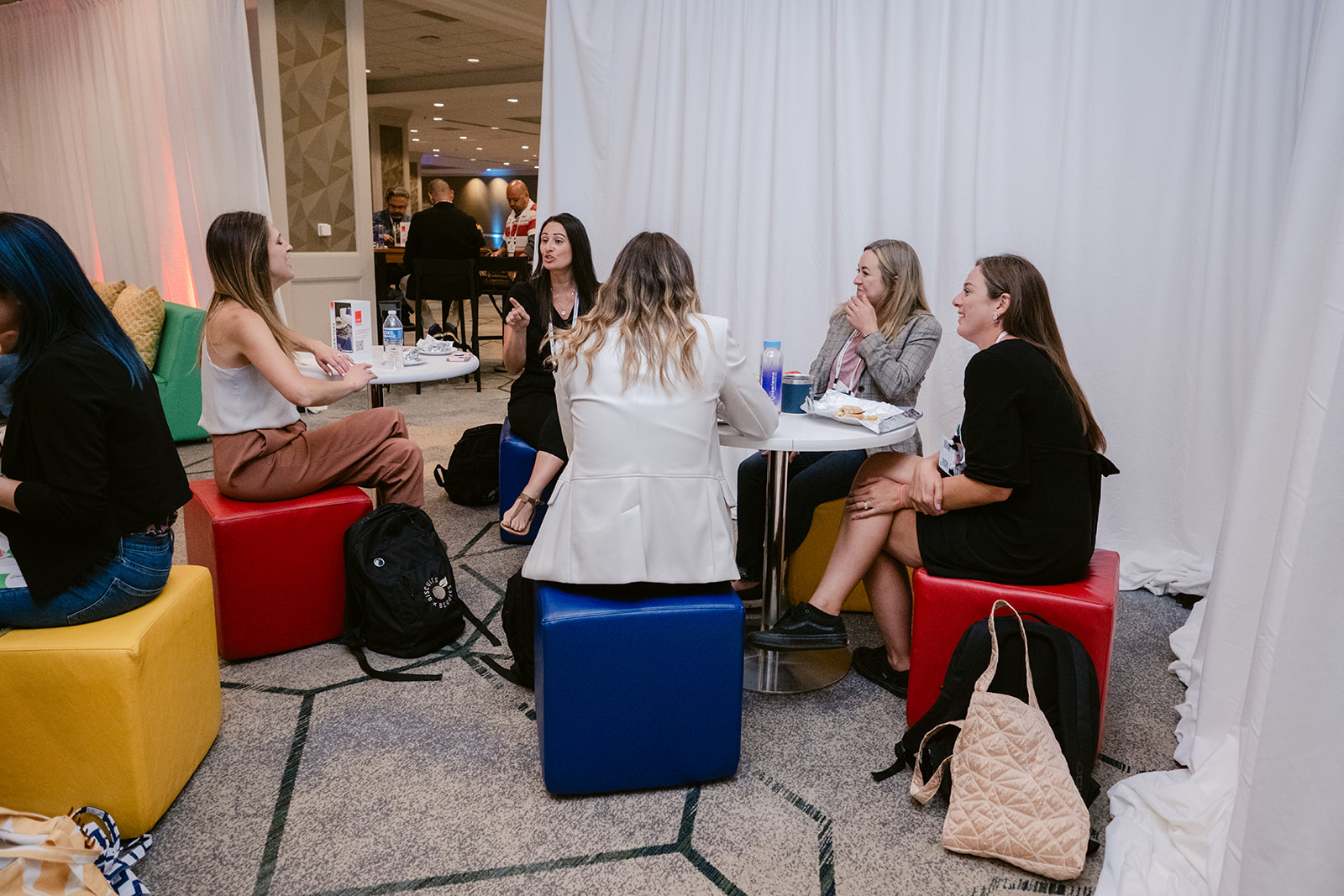 Attendees Sitting on Furniture in the CORT Lounge on Day 2 at 2024 NACE Experience Conference