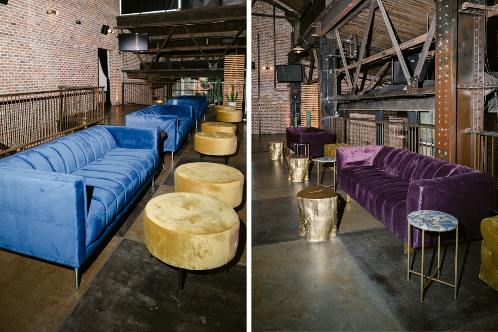 blue and purple velvet couches with accent tables in industrial lounge