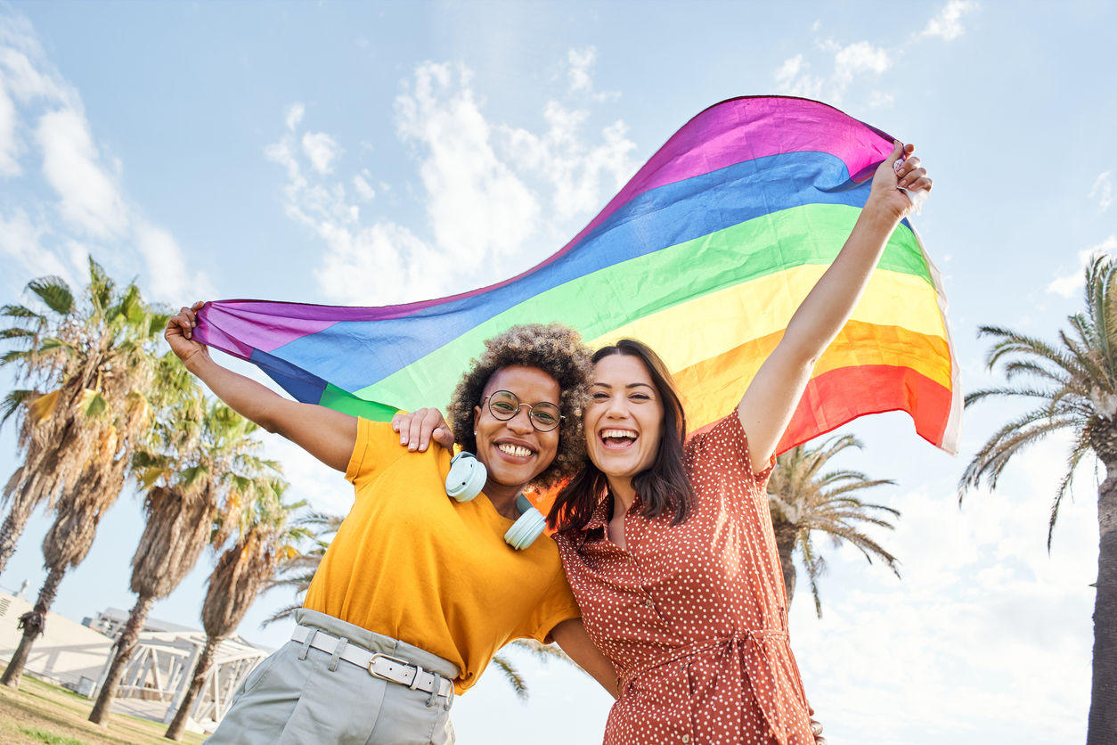 same sex couple with pride flag